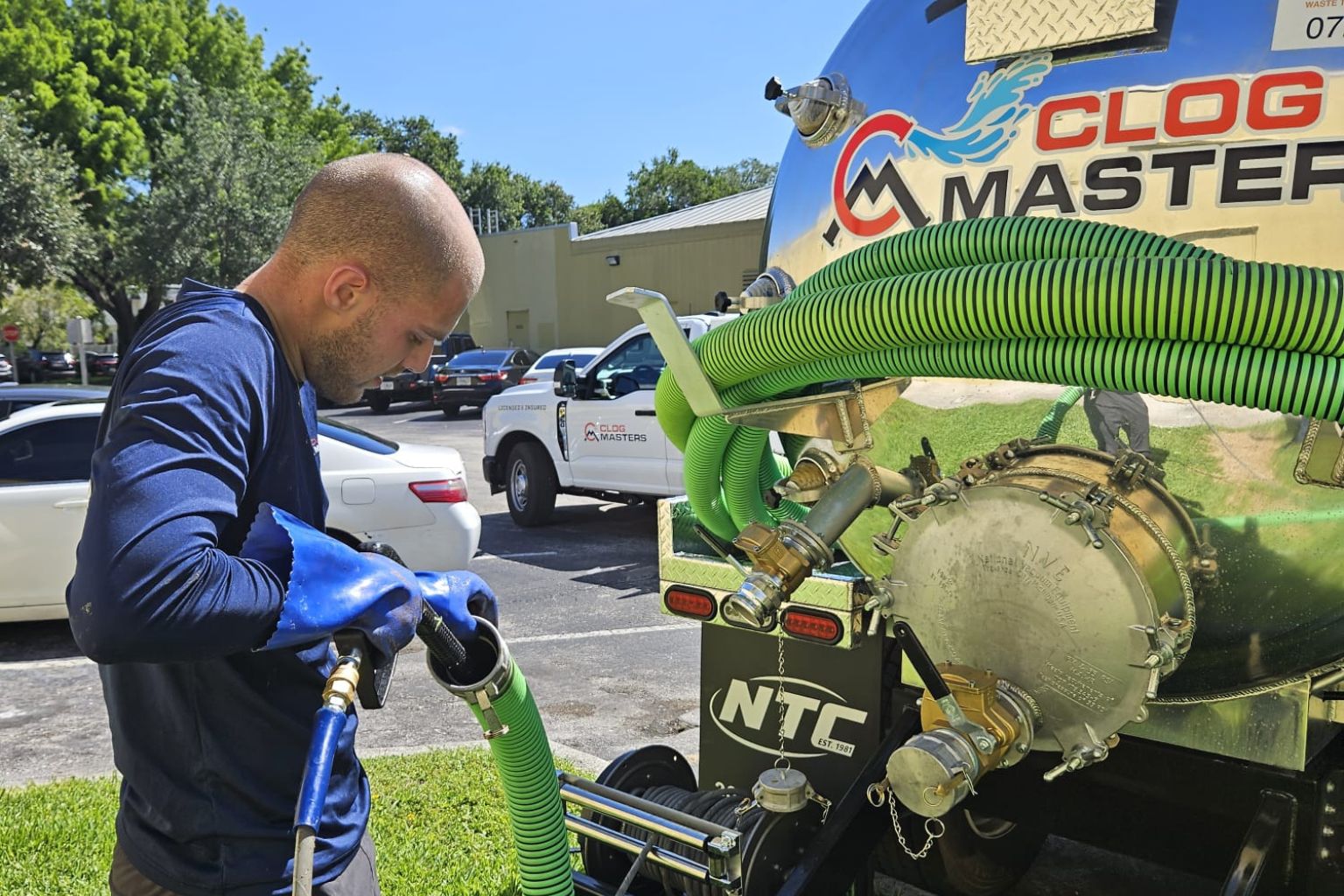 Drain Cleaning in Hollywood FL 2 ClogMasters technician preparing hydro jetting equipment for a drain cleaning job in Hollywood, FL